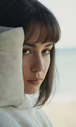 a young woman is holding a pillow over her head