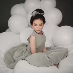 a woman is sitting in the middle of a bed