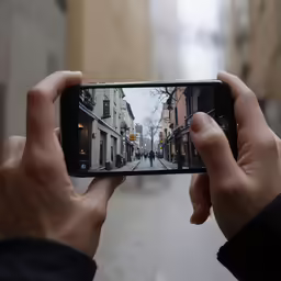 someone holding up their phone to take a picture
