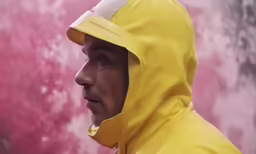 a man in yellow with a white face