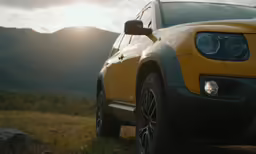 the front end of a jeep is shown at dusk