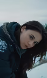 a young woman is in the snow posing