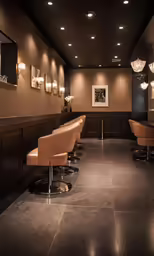 a room with bars, stools and pictures on the wall