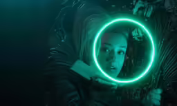 a woman holding a neon green circle on her hands