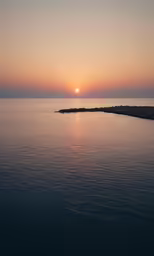 the sun sets on a quiet sea shore