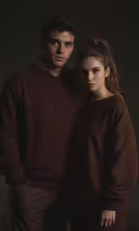 a young man and woman in black clothing
