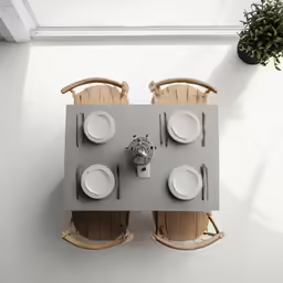 two chairs are sitting in front of a table with plates and plates