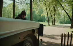 a man looking at the top of a truck