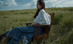 the girl is sitting on the lawn chair alone