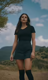 a woman in tights and heels is walking down a dirt road