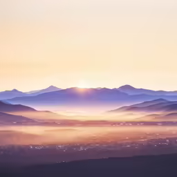 the sun shines brightly over the mountainous landscape