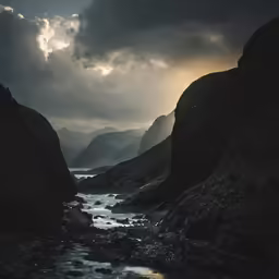 the view from a narrow riverbed with dark, cloudy skies