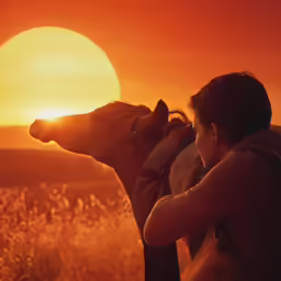 the woman is holding her dog up to his face