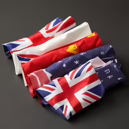 three bags of different countries on a dark surface