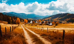 an empty dirt road in front of the mountain range