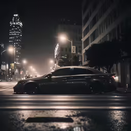 a black car stopped at an intersection in the city