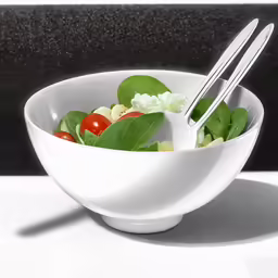 there is a bowl that has a salad in it