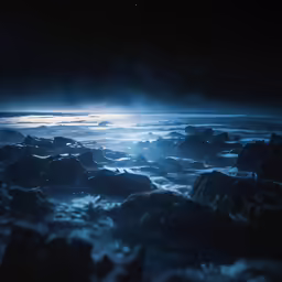 the view from an airplane shows a foggy seas, rocks, and stars