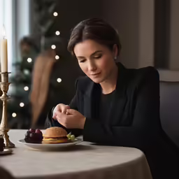 a woman eating a hamburger on a plate