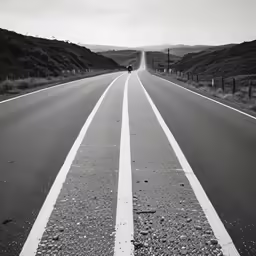 a street with two lines on it and a person walking down one