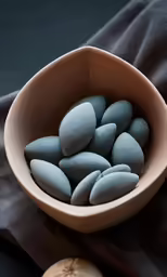 the stones are in the bowl on the fabric