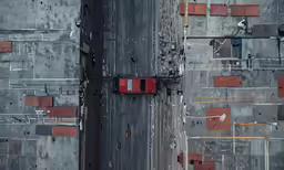 red car on a gray and asphalt road in the city