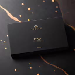 a black box with a gold foiled logo on it