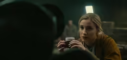 young woman taking a photo with her coffee mug
