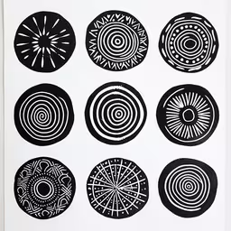 four different circles of black and white ink,six circles of black on white paper