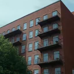 a red brick building with balconies on the top