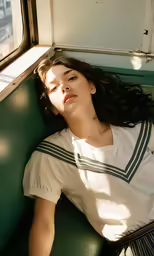 a woman lying in the seat of a vehicle