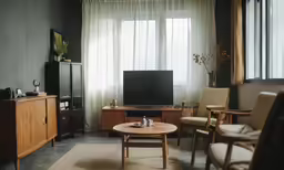 a living room with furniture and large windows