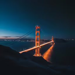 a view of the golden gate bridge lit up at night