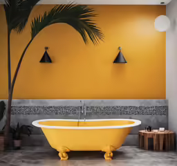 an orange bathroom with a tree on the wall