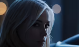 a blonde woman is sitting in a car