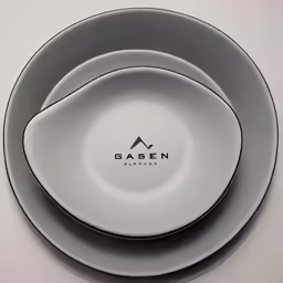 a table with three plates sitting on top of it