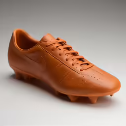 a shoe that is made with leather and is in the shape of a football boot