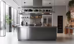 an open kitchen with stainless steel cabinets and shelves