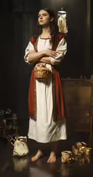 a woman standing wearing white and red in a studio