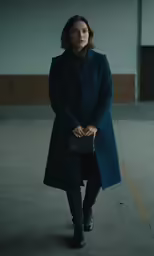 a woman is walking alone in the empty building