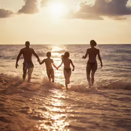 there are four people walking through the ocean