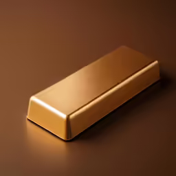 gold colored metal item resting upon a brown table
