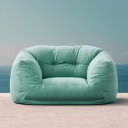 a chair sitting on a beach shore by the ocean