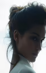 the beautiful brunette has a high bun in her hair