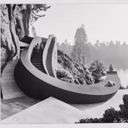 a large staircase near a hill with trees and stairs