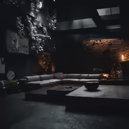a black room with a big long couch and a table