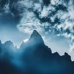 a photo of the sky and mountains and some clouds