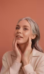 a woman with grey hair, wearing a trench coat