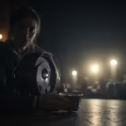 a woman looking down at a light that is turned on