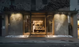 a store front with lit lights in winter
